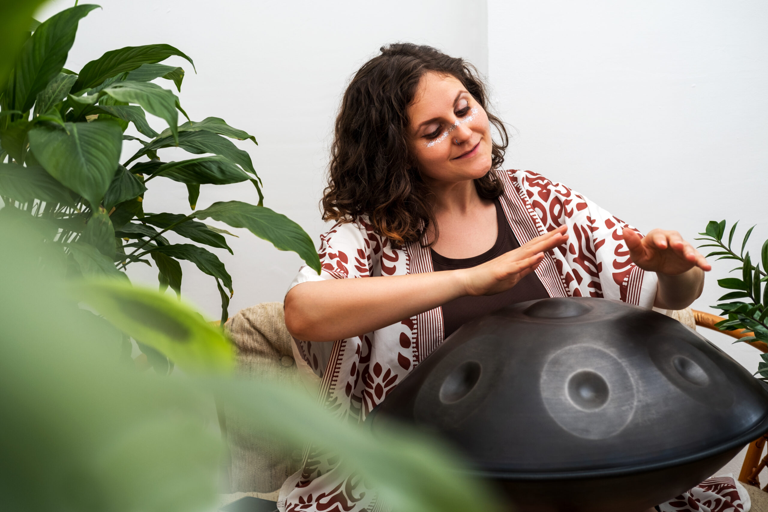 Beautiful young woman plays relaxing music with hang drum. beautiful young woman plays relaxing music with ha 2025 03 06 14 16 48 utc scaled