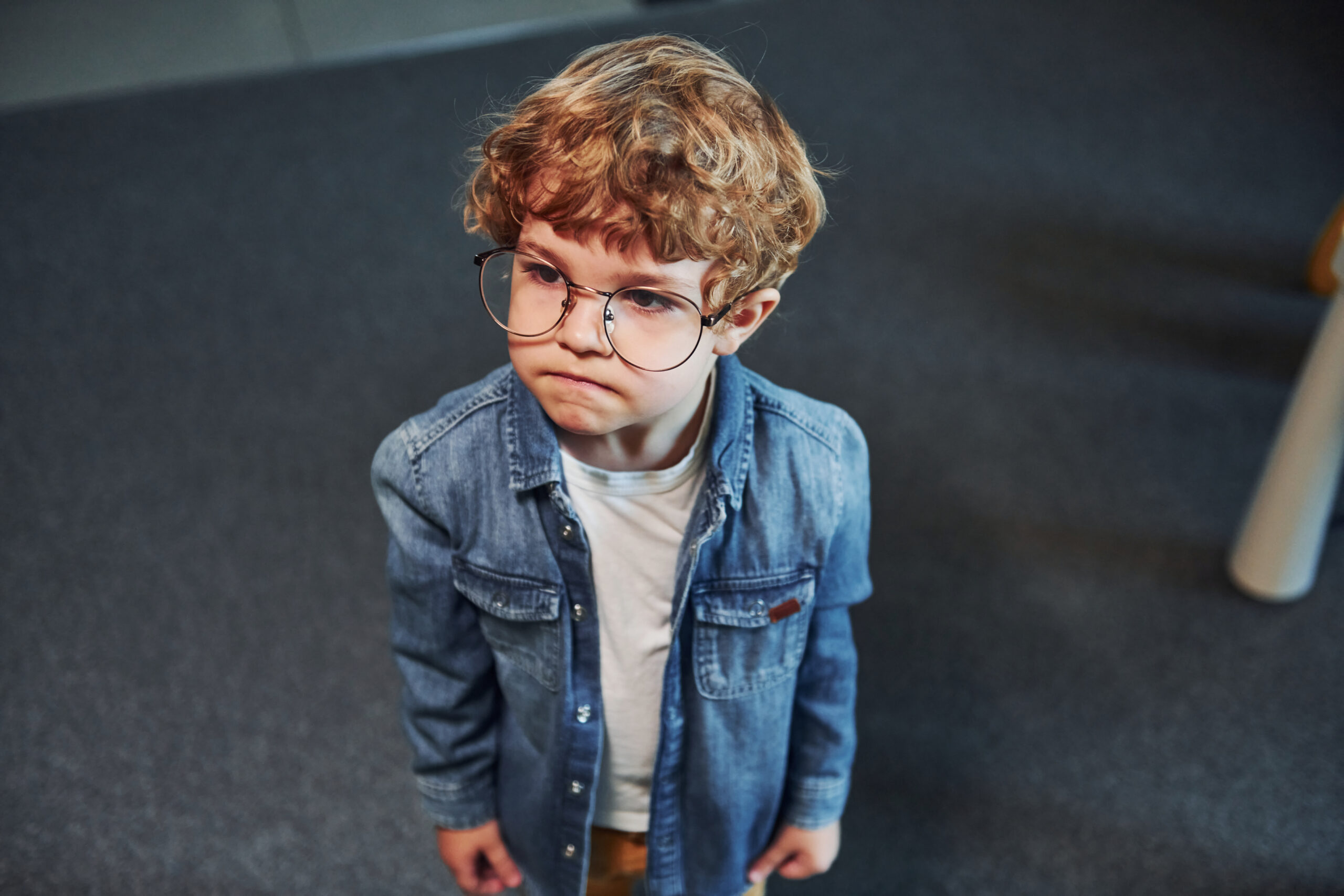pensive boy with round glasses and denim shirt 2026 03 24 07 06 22 utc scaled