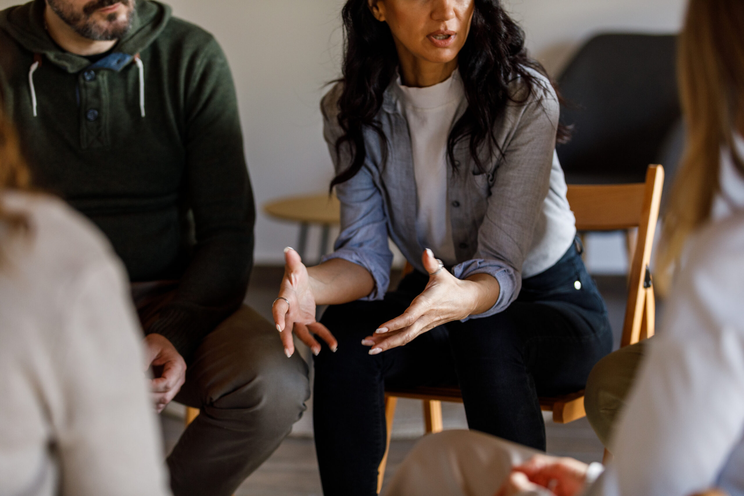 Anxious young woman sharing her struggles with her peers during a group therapy session iStock 1492995618 scaled