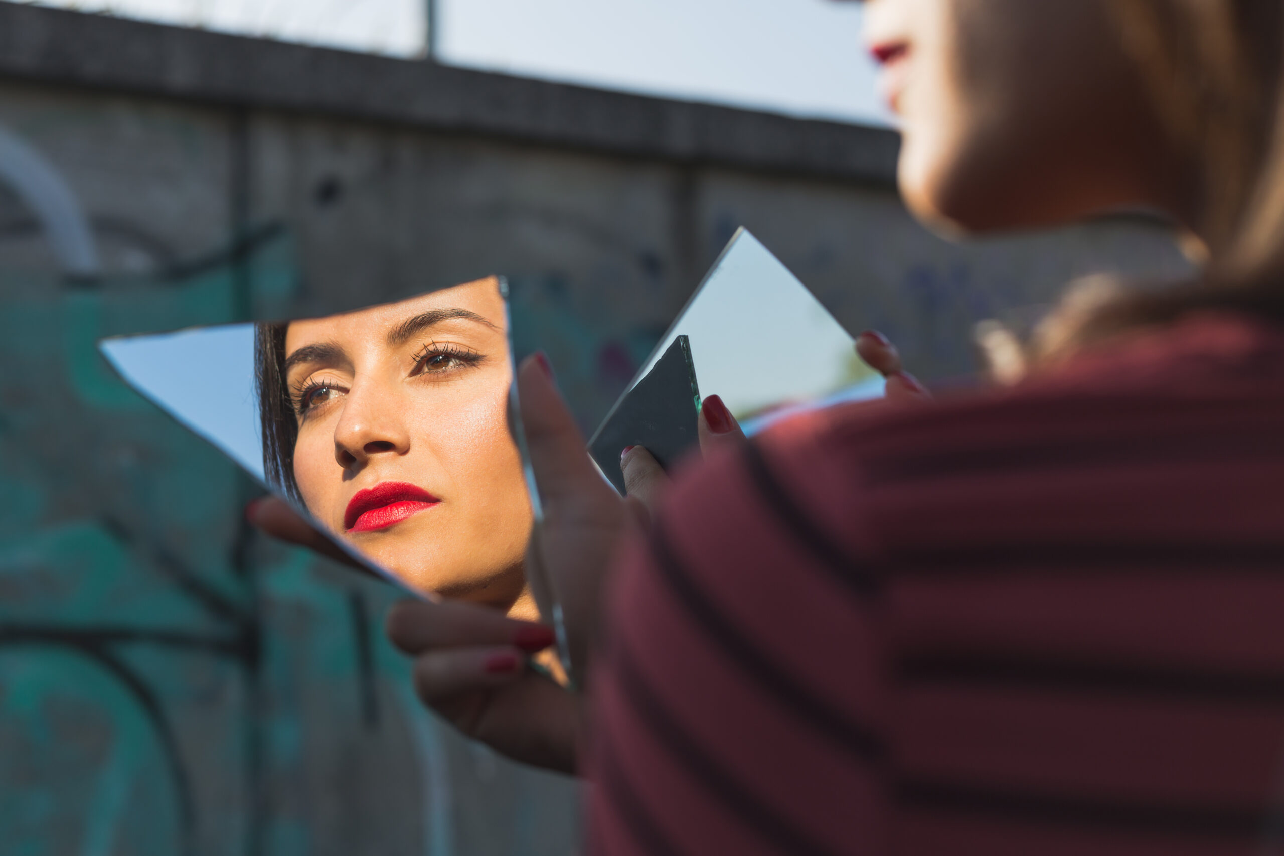 woman holding broken mirror reflecting her face 2026 09 22 13 35 58 utc scaled